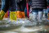Tourists try to stay dry in a flooded St Mark’s Square in Venice, Italy